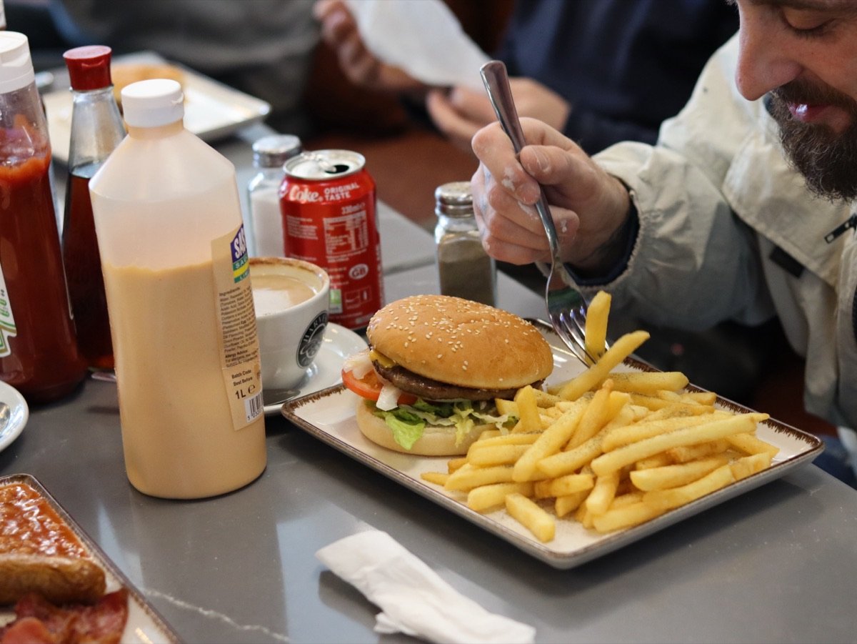 Beef burger and chips being enjoyed by a customer at Canons Cafe in Canons Park, Edgware