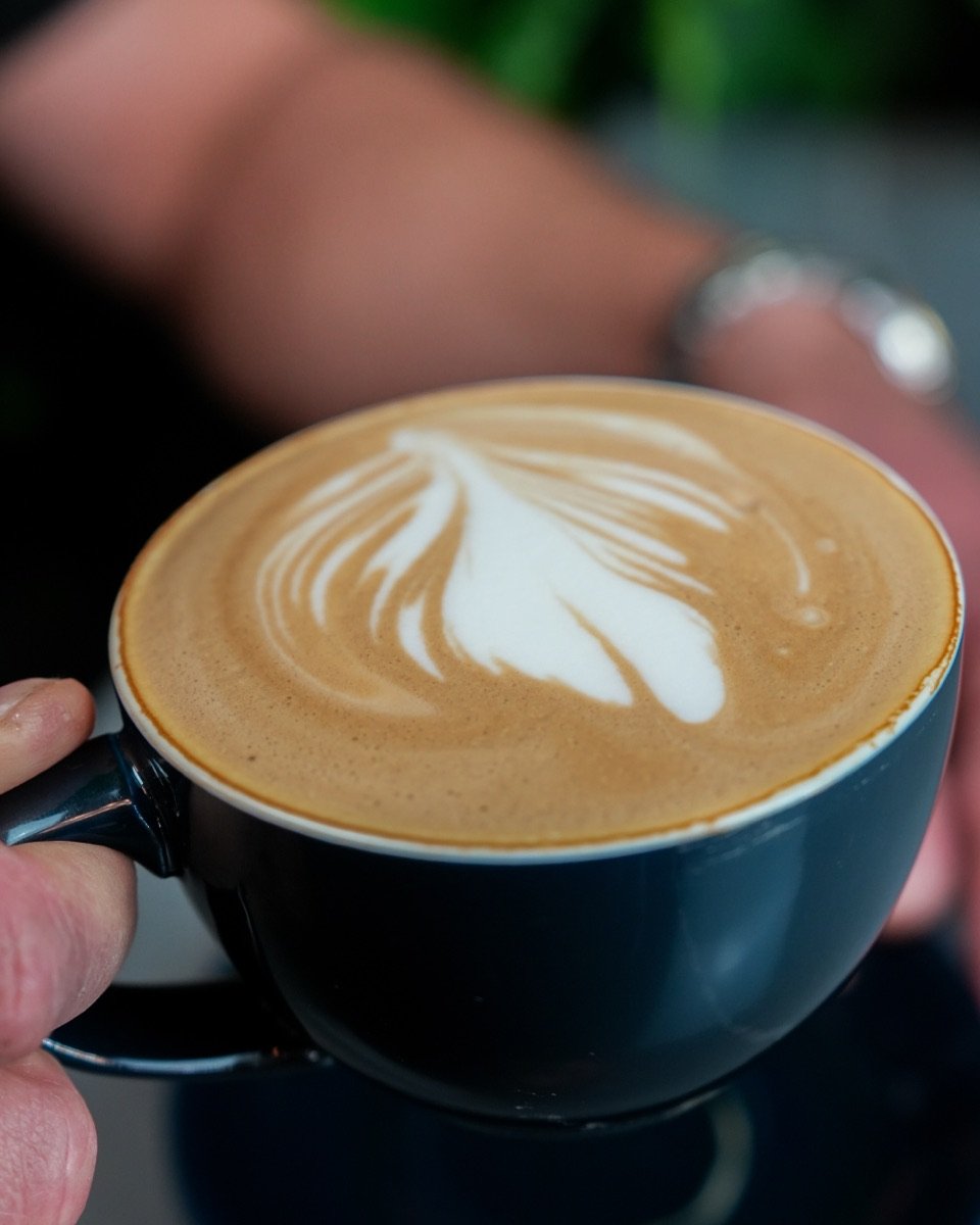 Flat white with latte art at Canons Cafe in Edgware