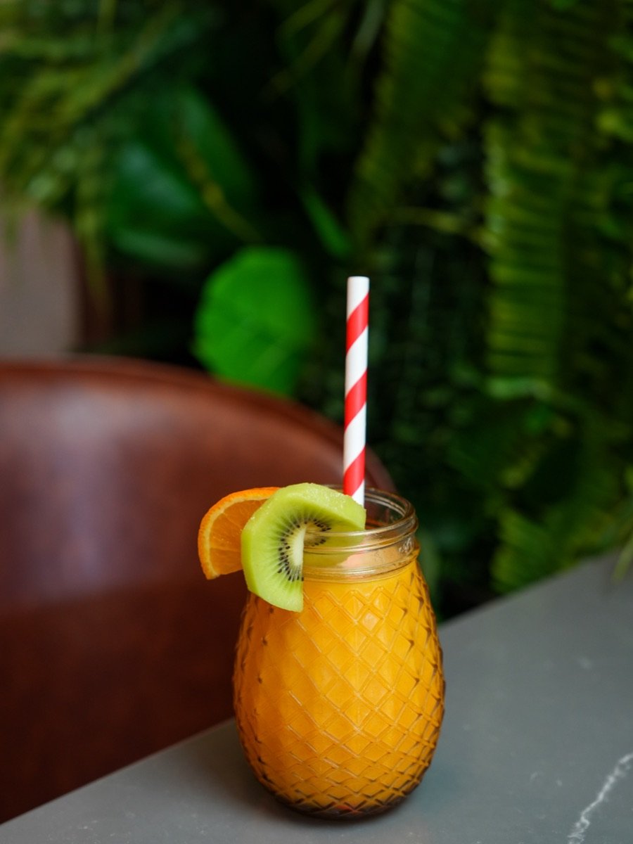 Freshly squeezed orange juice garnished with kiwi and orange at Canons Cafe, Canons Park