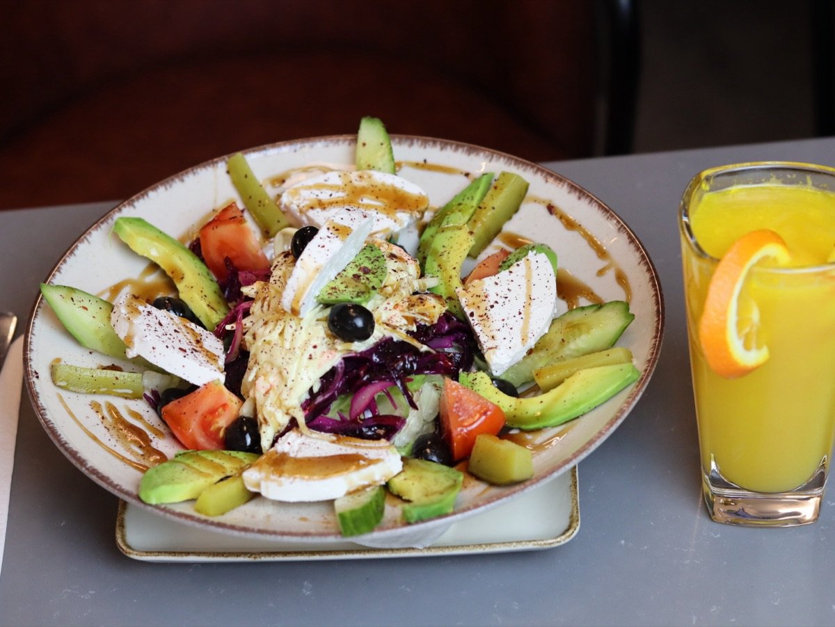 Halloumi and avocado salad with olives and fresh orange juice at Canons Cafe in Edgware