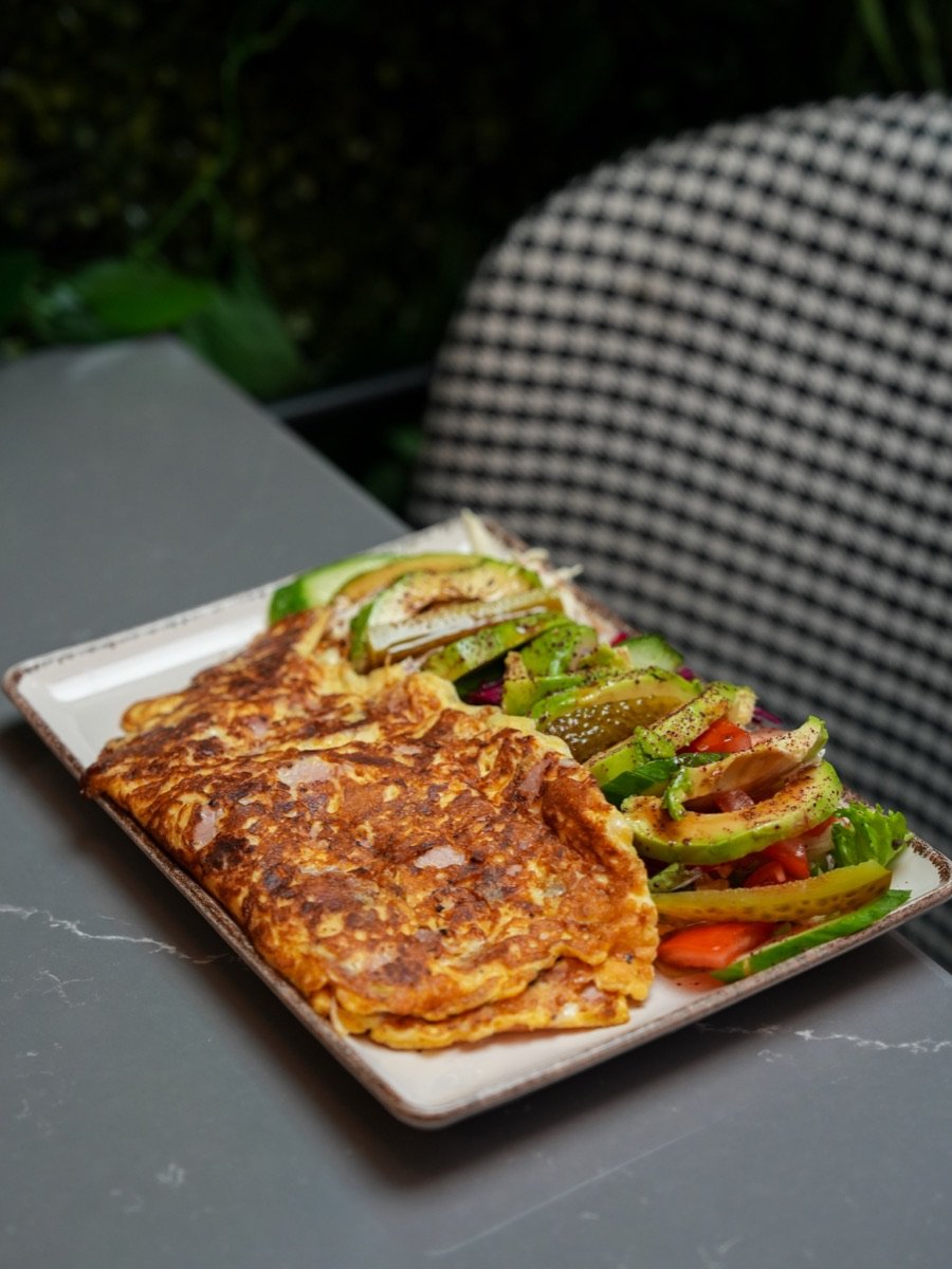 Three-egg omelette served with an avocado and tomato salad at Canons Cafe, Canons Park