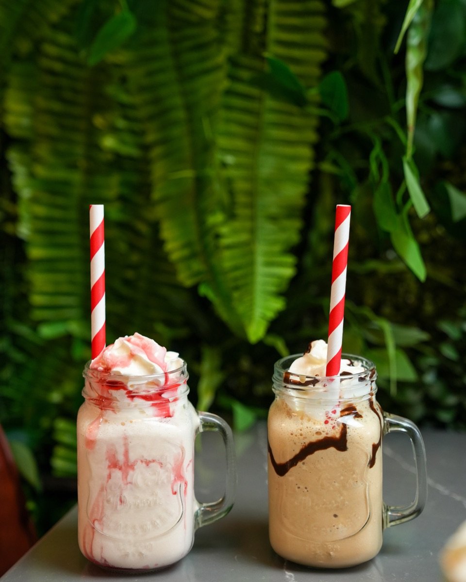 Strawberry and chocolate milkshakes topped with whipped cream at Canons Cafe in Edgware